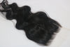 A wavy, black undetectable thin hd lace hair closure with a realistic appearance.