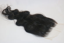  A wavy, black undetectable thin hd lace hair closure with a realistic appearance.