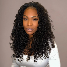  Woman with long, curly black hair against a plain background