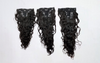 three sets of wavy clip-in hair extension sets laid side by side against a white surface.