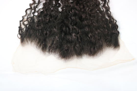 undetectable thin hd lace frontal in the e-curly texture laid against a white surface