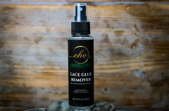 4 oz. bottle of lace glue remover with a wood background