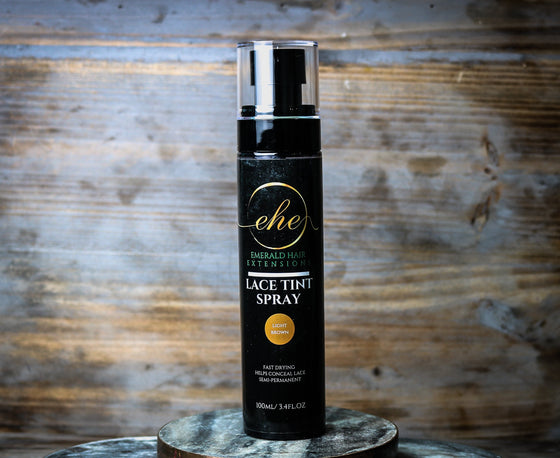 3.4 oz. light brown lace tint spray bottle against a wood background