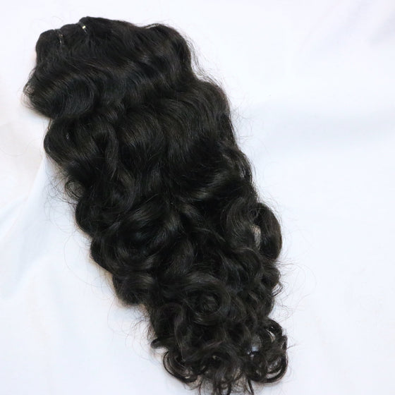 a bundle of black natural curly hair extensions on a white background
