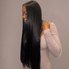 Woman with long straight black hair styled in a straight manner against a neutral background