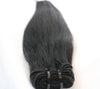 bundle of black straight hair extensions laid against white background