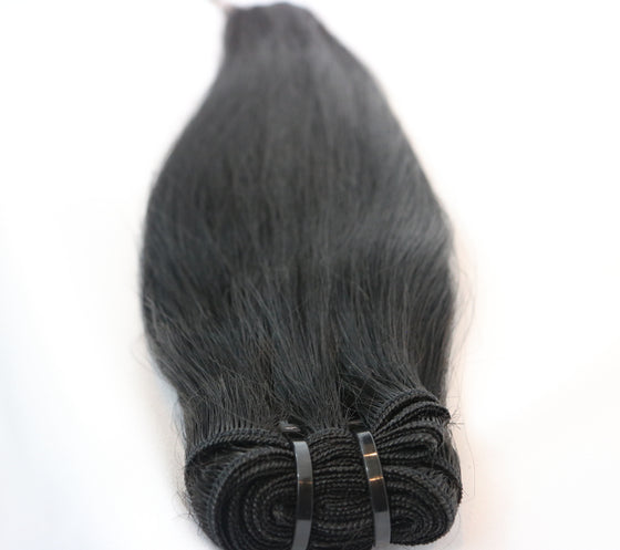 bundle of black straight hair extensions laid against white background