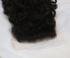 A closure in the texture natural curly laid out on a white surface.