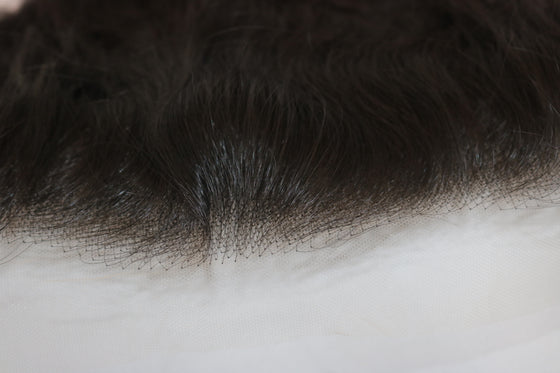 close-up of thin hd lace frontal laid against a white surface