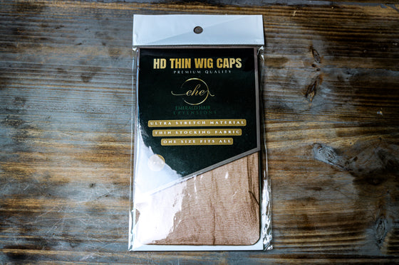 thin hd wig cap in coffee shade against wooden surface