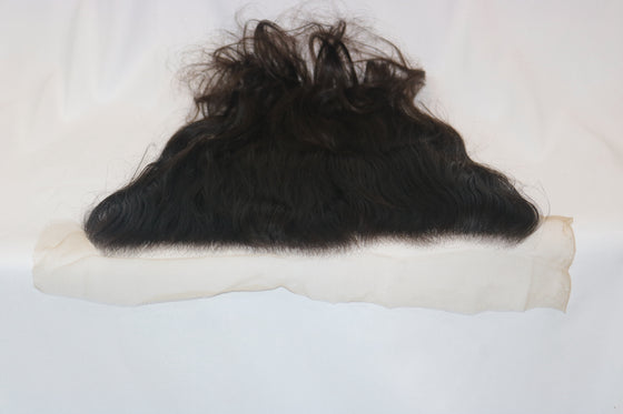 ultra thin transparent lace frontal in the wavy texture laid against a white surface