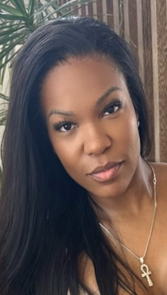 woman wearing undetectable thin hd lace, a gold necklace with a plant in the background