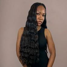  Woman with long, wavy hair against a plain background